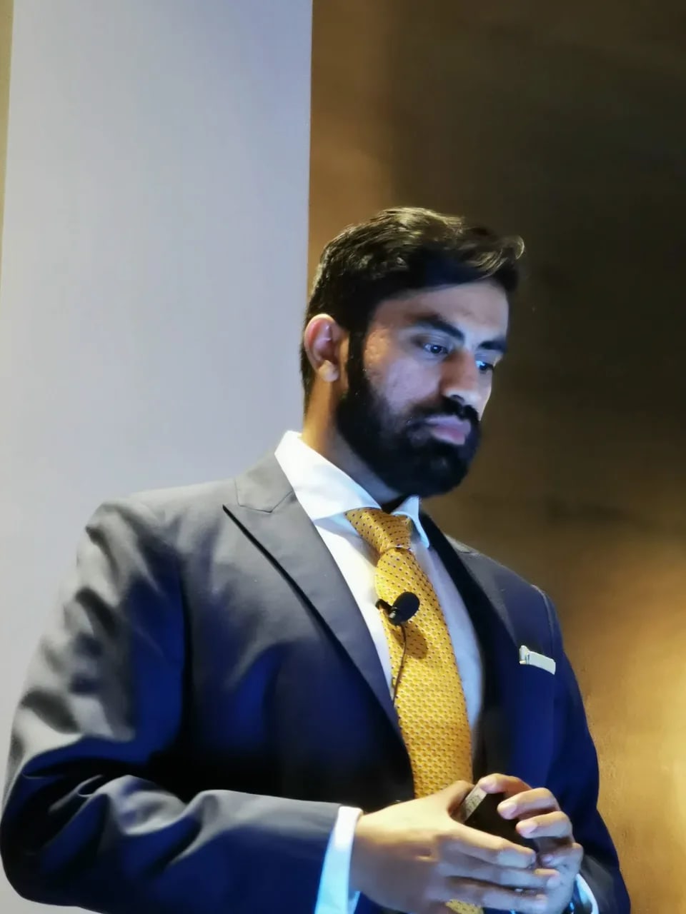 Owais speaking on stage